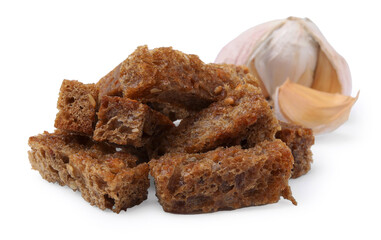 Delicious crispy rusks and garlic on white background