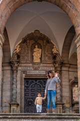 Mother and son tourists at the door of the Sanctuary of Loyola, Baroque church of Azpeitia