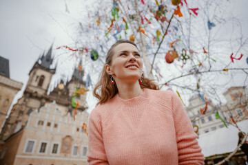 modern woman in pink blouse at fair in city