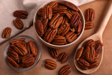 Flat lay composition with tasty pecan nuts on wooden table