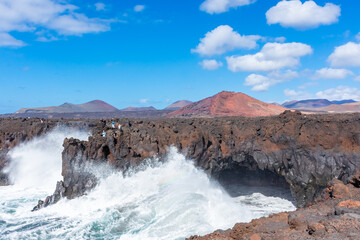 Powerful waves of the Atlantic Ocean crashing on the volcanic cliffs of Los Hervideros in Lanzarote, Canary Islands, Spain