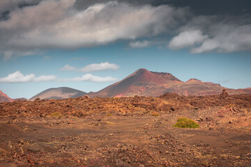 Fototapeta na wymiar Wild volcanic landscape of the Timanfaya National Park, Lanzarote, Canary Islands, Spain
