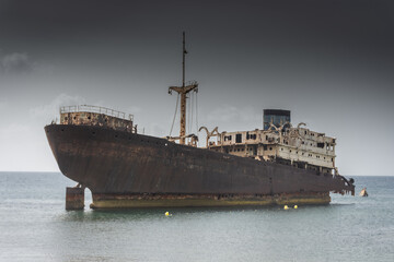 The Telamon shipwreck on the sea under a cloudy sky in Lanzarote Island , Spain