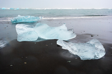 Diamond Beach in Iceland. Incredible Landscape with Pure Blue Icebergs on Black Sand. Shore Near Jokulsarlon glacier lagoon. Global Warming Concept. Vatnajokull National Park, southeast Iceland