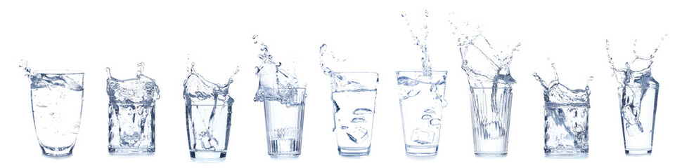 Set of many glasses with splashing water isolated on white