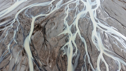 Glacial rivers from above. Aerial photograph of the river streams from Icelandic glaciers. Beautiful art of the Mother nature created in Iceland. Wallpaper background 