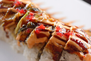 Artistic closeup of sushi red dragon roll with caviar