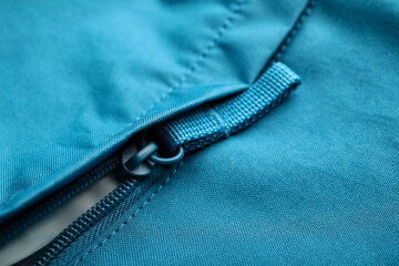 Closeup view of blue clothes with zipper