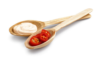 Wooden spoons with tasty chipotle sauce on white background