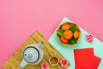 Chinese language mean rich or wealthy and happy.Top view aerial image decoration Chinese new year  lunar new year holiday background concept.Flat lay red orange with blossom on modern  paper.