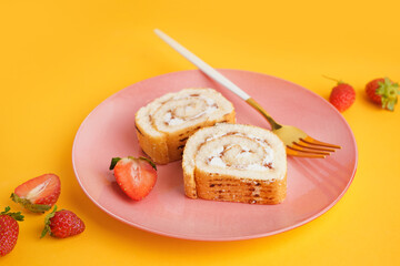 Plate with pieces of sponge cake roll and strawberry on color background