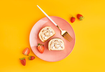 Plate with pieces of sponge cake roll and strawberry on color background