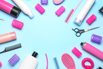 Frame made of hair care products and accessories on blue background