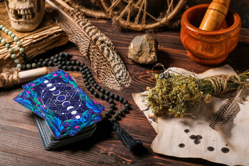 Tarot cards and magic attributes on wooden table