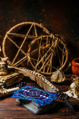 Tarot cards and magic attributes on wooden table