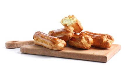Wooden board with sweet eclairs on white background