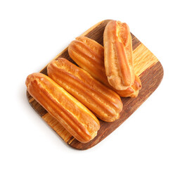 Wooden board with sweet eclairs isolated on white background