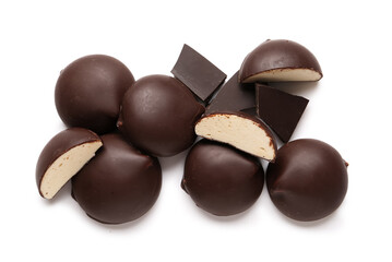Heap of sweet chocolate bird's milk candies on white background
