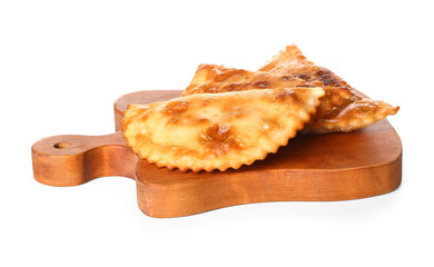 Cutting board with tasty chebureks on white background