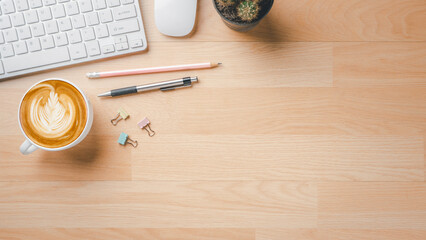 Office desk workspace with keyboard computer, mouse, pen, pencil and cup of coffee, Top view flat lay with copy space.