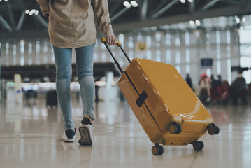 International airport terminal. Asian beautiful woman with luggage and walking in airport