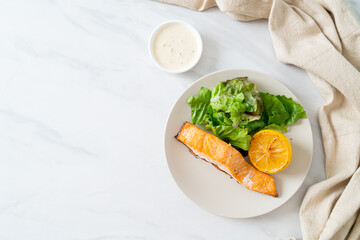 fried salmon steak with lemon and vegetable