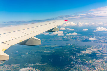 Obraz premium View from the airplane window during taking off on a clear summer morning. Yekaterinburg, Russia