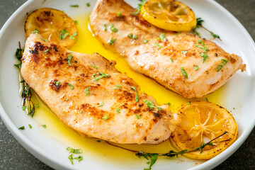 grilled chicken with butter, lemon and garlic - obrazy, fototapety, plakaty