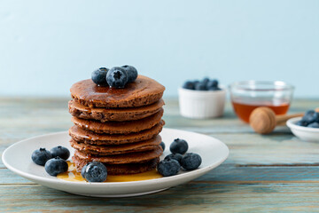 chocolate pancake stack with blueberry and honey