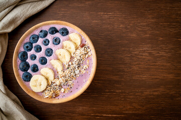 yogurt or yoghurt smoothie bowl with blue berry, banana and granola