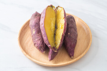 Grilled or baked Japanese sweet potatoes on wood plate