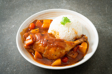 chicken stew with tomatoes, onions, carrot and potatoes on plate with rice