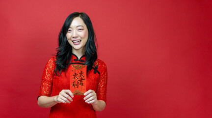 Asian woman holding red money fortune envelope blessing Chinese word which means 