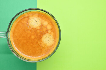 glass of hot black coffee put on green background