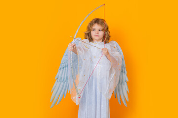 Kid cupid hold bow and arrow. Christmas kids. Little cupid angel child with wings. Studio portrait...