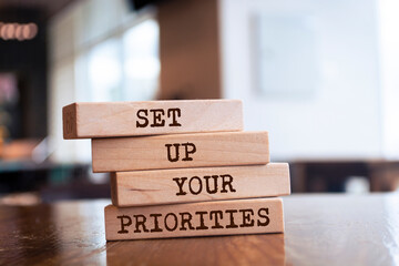 Wooden blocks with words 'SET UP YOUR PRIORITIES'. Business concept