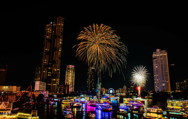BANGKOK, THAILAND - JANUARY 1,2023 : The countdown firework show at Asiatique Riverfront in Bangkok. Colourful of fireworks on the river on Chao Praya River.