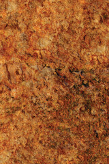 Raw pegmatite feldspar igneous rock terracotta pattern, rusty orange red golden amber yellow vertical background, coarse light crystals  texture, large detailed bright textured minerals macro closeup - 557808652