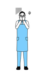 落ち込んで顔を覆うエプロンを着たシニア男性