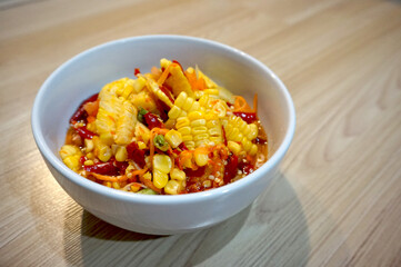 Corn spicy salad thai food on the wood table.