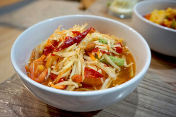 Som Tum Thai Food in White Cup On the Table.