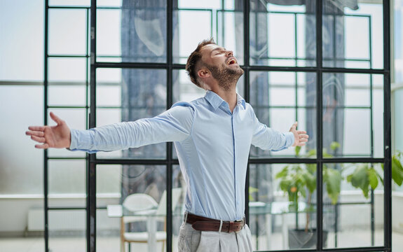 Head shot portrait smiling confident businessman wearing standing in modern office