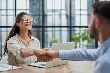 Fototapeta premium Handshake of business people sitting at the table in the office