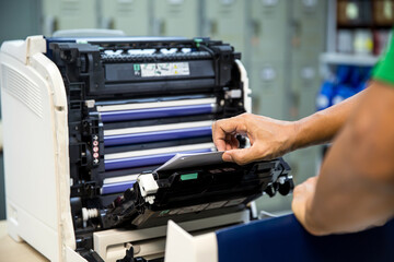 Technician hand open cover photocopier or photocopy to fix repair copier paper jam and replace ink...