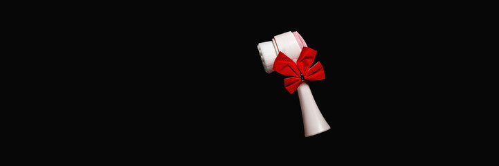 Face brush with Christmas bow. Gift for women on holiday. Banner.