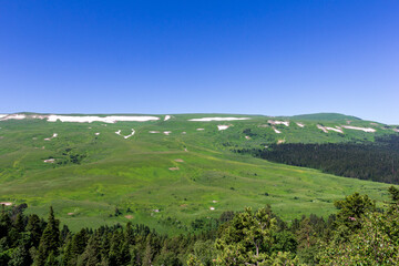 Summer, mountainous terrain, hiking trails running through the park, a place for walking and recreation.