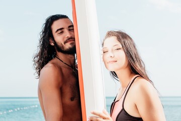 Woman man sea sup. Close up portrait of beautiful young caucasian woman with black hair and...