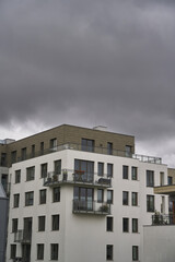 Concept of modern architecture for a better living. Contemporary medium-sized flat building in Europe. Sunset in a European middle house apartment