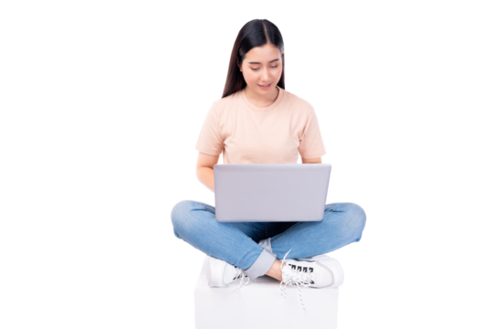 Happy young asian woman sitting on white chair with legs crossed and using laptop computer on light pink background copy space Full body young smiling happy female wearing t shirt and jeans lifestyle - Powered by Adobe