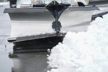 truck with snowplow installed in the parking lots - obrazy, fototapety, plakaty